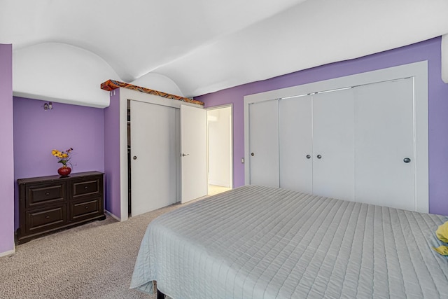 bedroom featuring carpet floors, lofted ceiling, and a closet