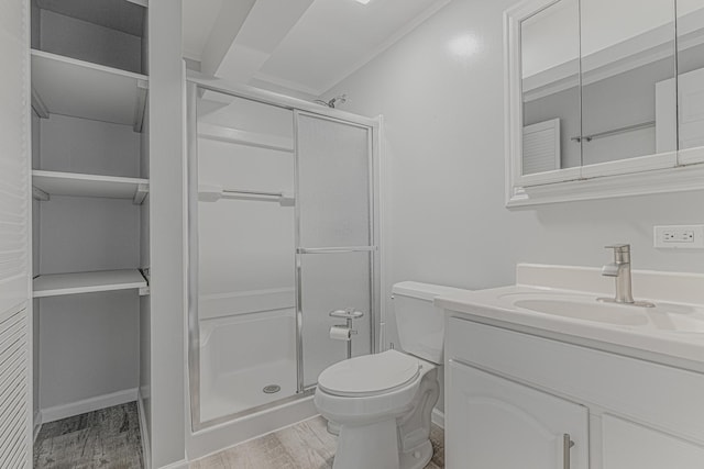 full bath featuring a shower stall, toilet, vanity, and wood finished floors