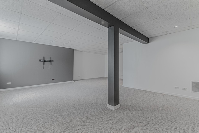 finished below grade area featuring a drop ceiling, carpet floors, baseboards, and recessed lighting