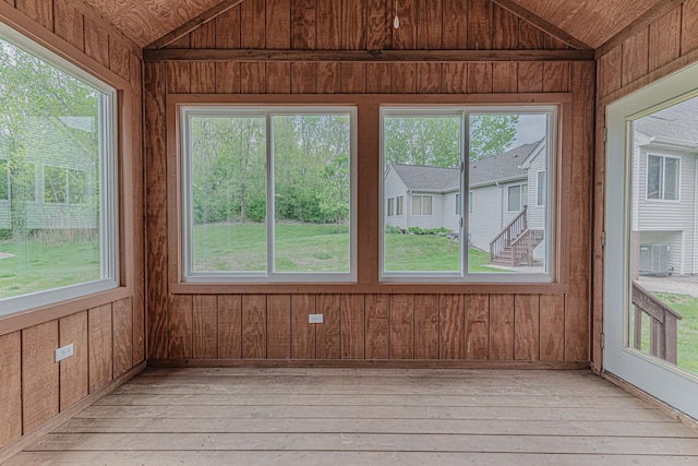 unfurnished sunroom with vaulted ceiling and healthy amount of natural light