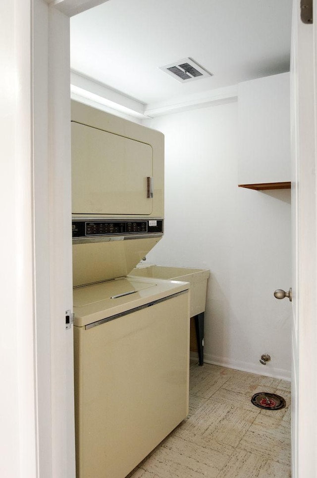 2700 E Bel Aire Dr Unit 304, Arlington Heights, IL 60004 - washroom with stacked washer / drying machine and baseboards