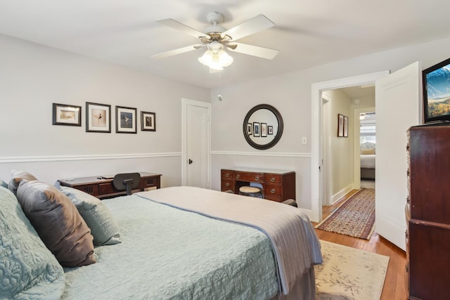 bedroom with wood finished floors and a ceiling fan