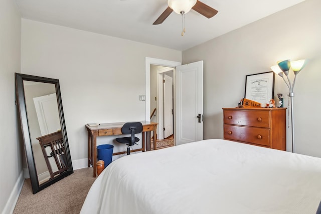carpeted bedroom featuring baseboards and ceiling fan