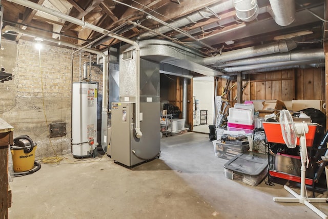 unfinished basement featuring gas water heater and heating unit