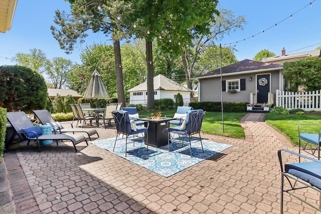 view of patio with a fire pit and fence