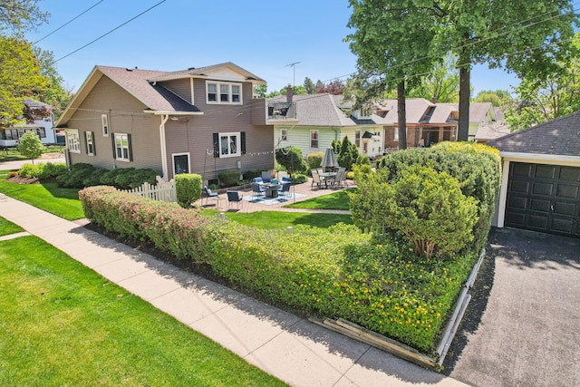 rear view of house with a yard and a patio