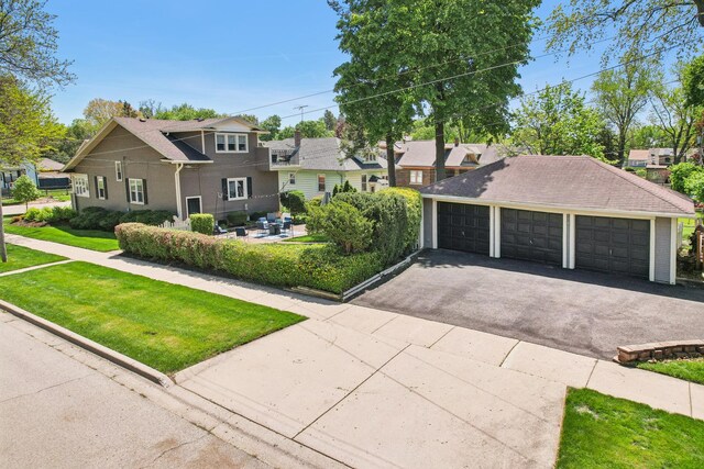 view of front facade with a front yard, a garage, and a residential view