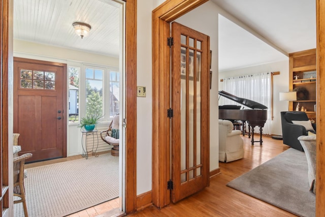 entryway featuring wood finished floors and baseboards