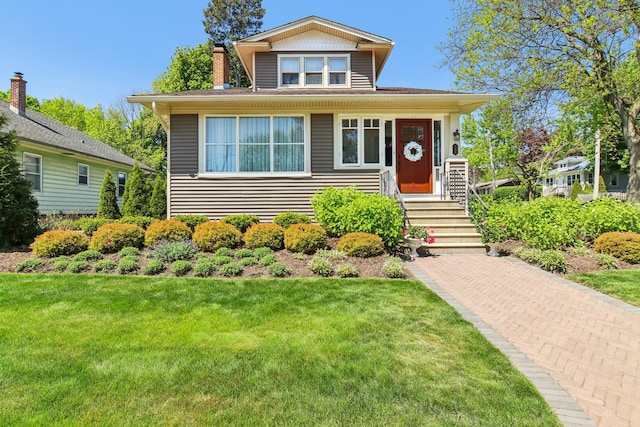 view of front of home featuring a front lawn and a chimney