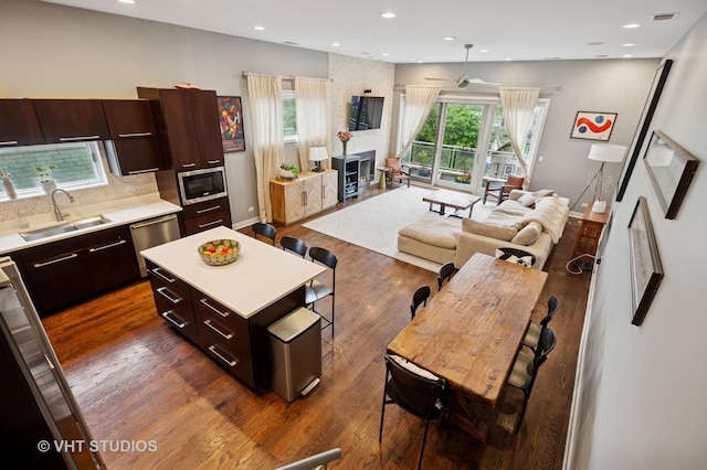 2116 W Barry Ave Unit 3, Chicago, IL 60618 - living room with dark wood-type flooring, ceiling fan, recessed lighting, baseboards, and a large fireplace