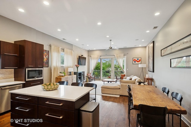 2116 W Barry Ave Unit 3, Chicago, IL 60618 - kitchen featuring stainless steel appliances, light countertops, dark wood finished floors, recessed lighting, and a center island