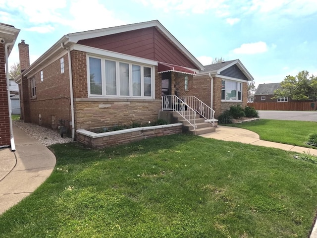 6209 N Nagle Ave, Chicago, IL 60646 - view of front of property with a front lawn, brick siding, and stone siding