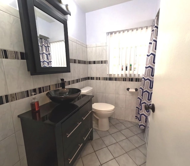6209 N Nagle Ave, Chicago, IL 60646 - bathroom featuring tile walls, tile patterned flooring, toilet, vanity, and curtained shower