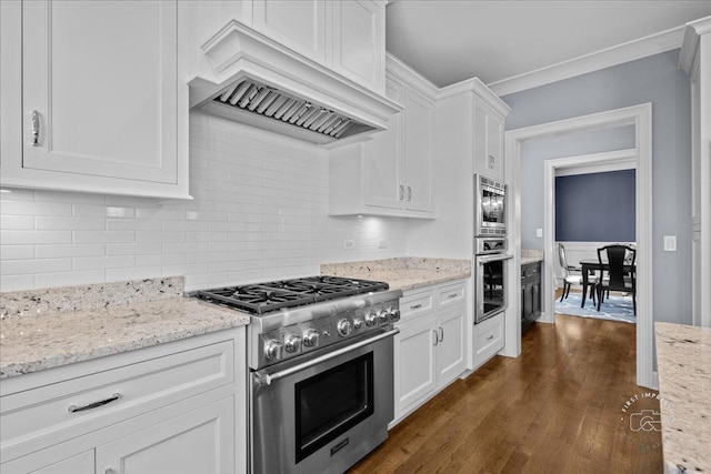 5233 Carpenter St, Downers Grove, IL 60515 - kitchen with appliances with stainless steel finishes, custom range hood, white cabinetry, backsplash, and dark wood finished floors