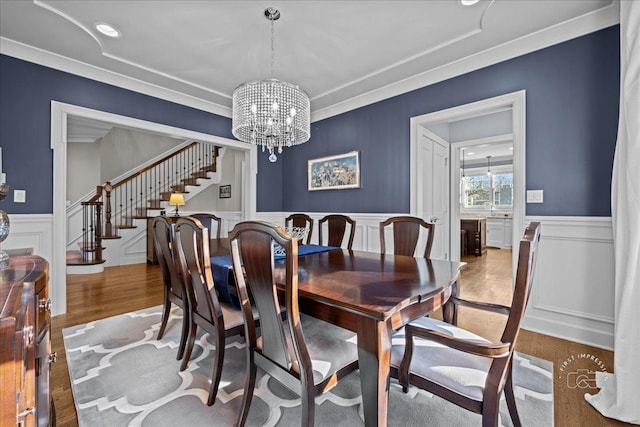 5233 Carpenter St, Downers Grove, IL 60515 - dining space with wood finished floors, a chandelier, wainscoting, stairs, and crown molding