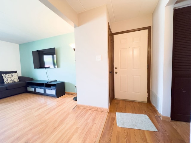 living room featuring light wood-type flooring and baseboards