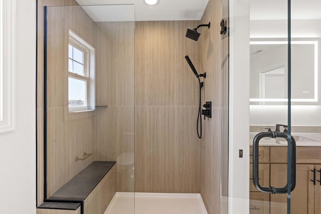 full bath with a shower stall and vanity