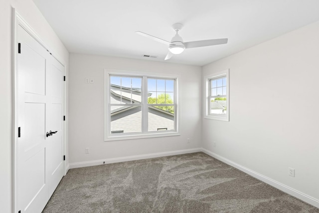unfurnished bedroom featuring carpet flooring, baseboards, and a ceiling fan