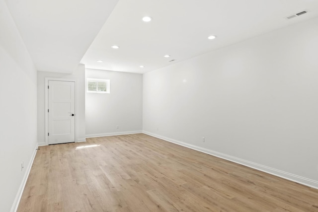 spare room featuring light wood-style floors, baseboards, and recessed lighting