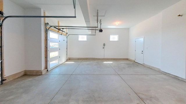 garage featuring baseboards and a garage door opener