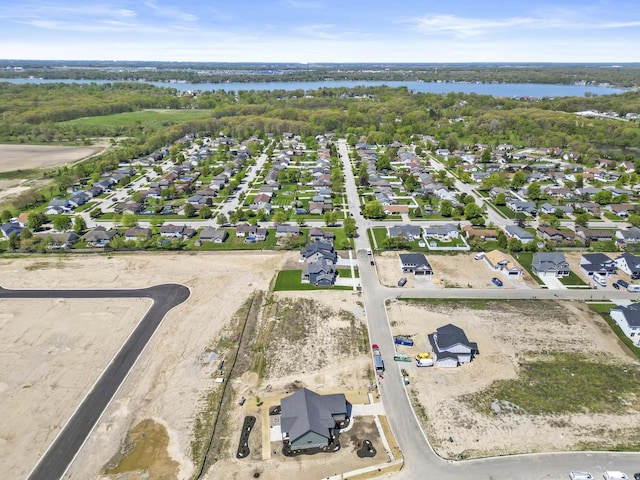 view of property location featuring a nearby body of water and nearby suburban area
