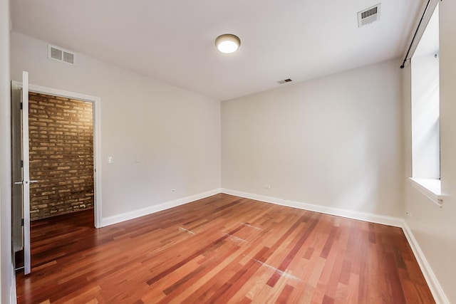 spare room featuring light wood-style flooring and baseboards
