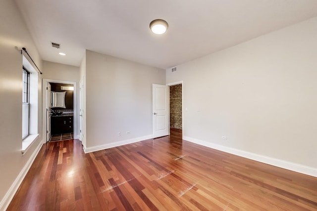 empty room with wood finished floors and baseboards