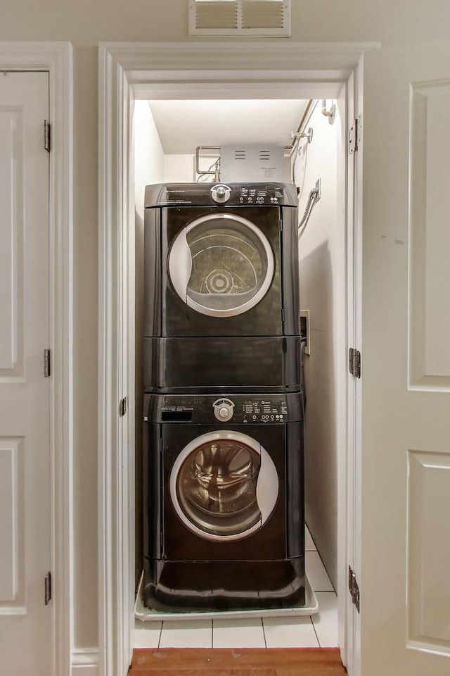 laundry room featuring stacked washer / drying machine