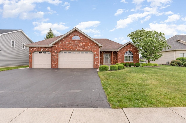 1073 Hawthorne Ave, Beecher, IL 60401 - view of front facade featuring brick siding, asphalt driveway, a front lawn, an attached garage, and roof with shingles