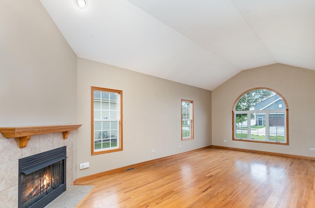 1073 Hawthorne Ave, Beecher, IL 60401 - unfurnished living room with a tile fireplace, vaulted ceiling, wood finished floors, and baseboards