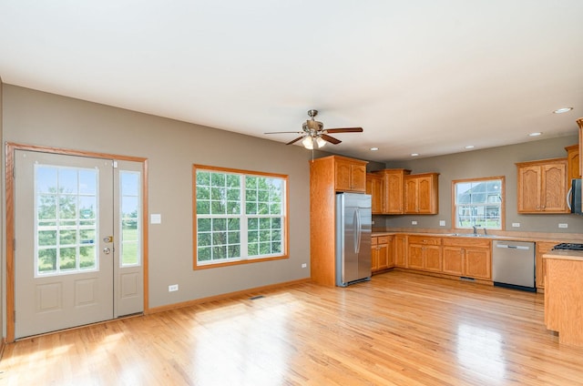 1073 Hawthorne Ave, Beecher, IL 60401 - kitchen with stainless steel appliances, light countertops, a sink, light wood finished floors, and recessed lighting