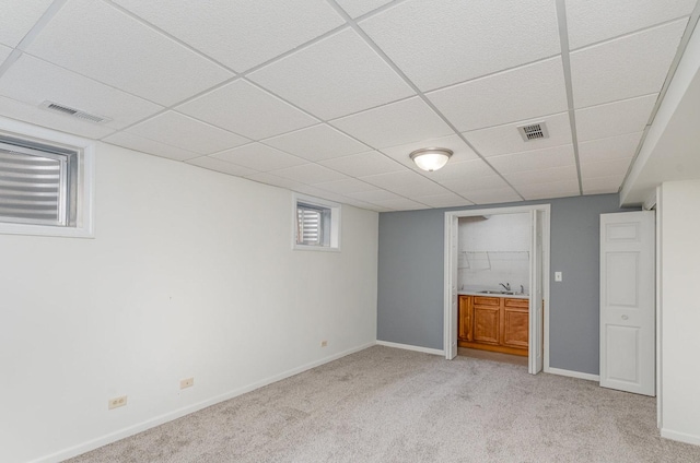 1073 Hawthorne Ave, Beecher, IL 60401 - below grade area featuring a sink, light carpet, baseboards, and a drop ceiling