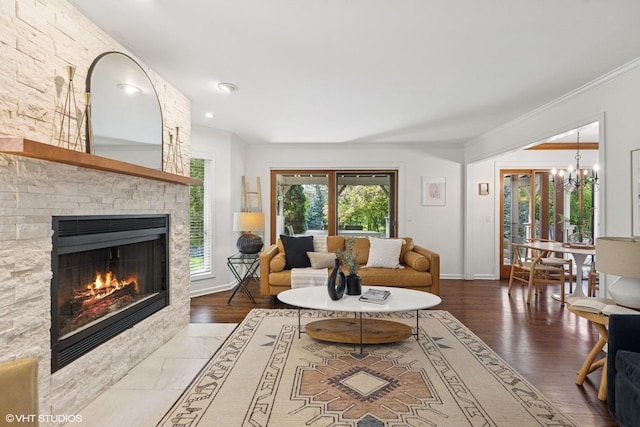2116 Nachtman Ct, Wheaton, IL 60187 - living room featuring a chandelier, ornamental molding, a fireplace, baseboards, and wood finished floors