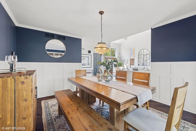 2116 Nachtman Ct, Wheaton, IL 60187 - dining area with a decorative wall, dark wood-style floors, ornamental molding, a wainscoted wall, and a chandelier