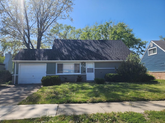 216 Washington St, Park Forest, IL 60466 - view of front facade with an attached garage, a front lawn, and driveway