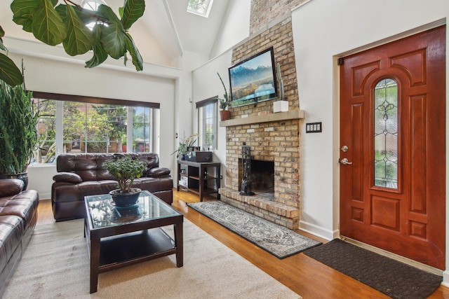 89 Huron St, Maywood, IL 60153 - living area with wood finished floors, vaulted ceiling, and a fireplace