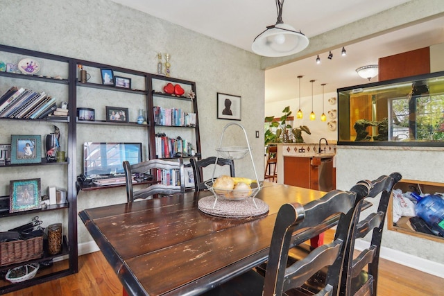 89 Huron St, Maywood, IL 60153 - dining room featuring wood finished floors, a textured wall, and baseboards