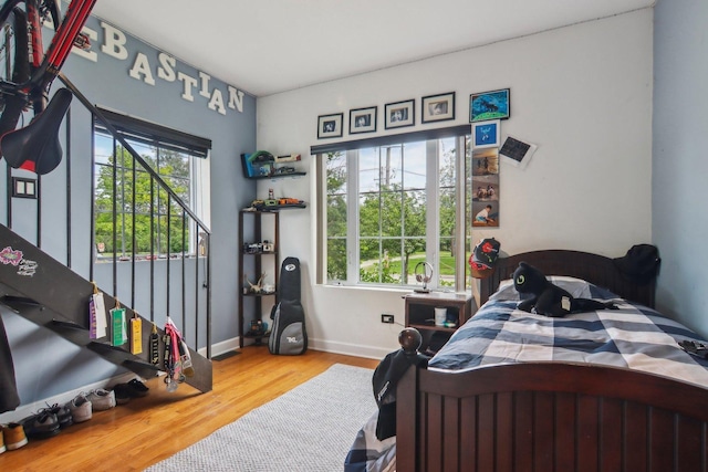 89 Huron St, Maywood, IL 60153 - bedroom with multiple windows, wood finished floors, and baseboards