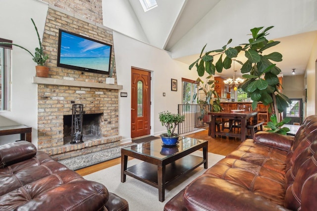 89 Huron St, Maywood, IL 60153 - living area with wood finished floors, lofted ceiling, a brick fireplace, and a chandelier