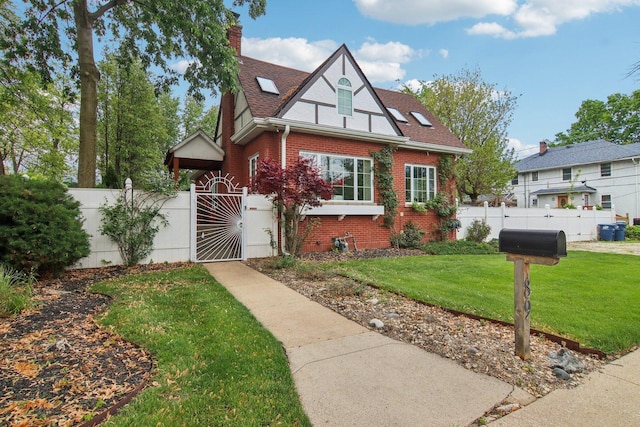 89 Huron St, Maywood, IL 60153 - english style home with a gate, brick siding, a chimney, and a shingled roof