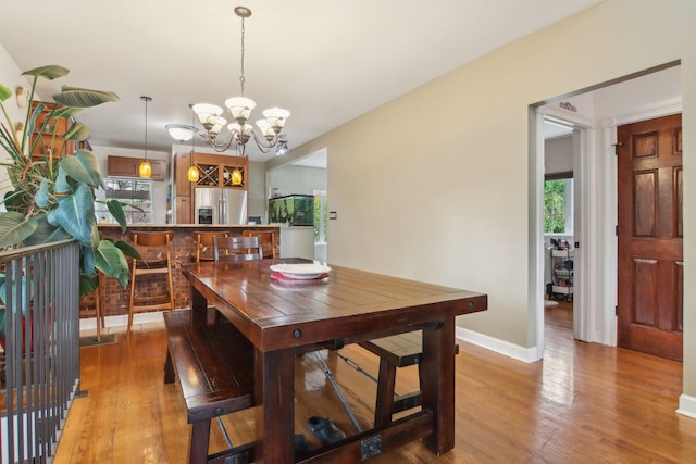 89 Huron St, Maywood, IL 60153 - dining space with a chandelier, light wood finished floors, and baseboards