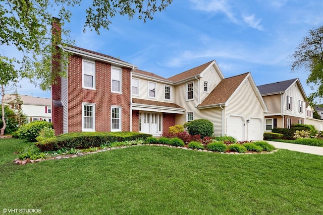 315 Carmelhead Ln, Schaumburg, IL 60193 - view of front facade featuring a chimney, a front yard, a garage, brick siding, and concrete driveway