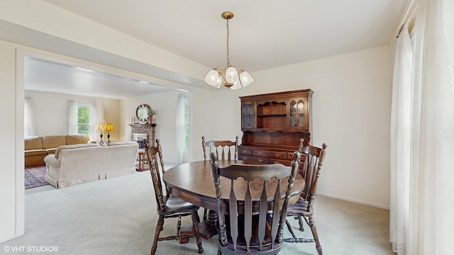 315 Carmelhead Ln, Schaumburg, IL 60193 - dining area with carpet floors, a chandelier, baseboards, and a fireplace