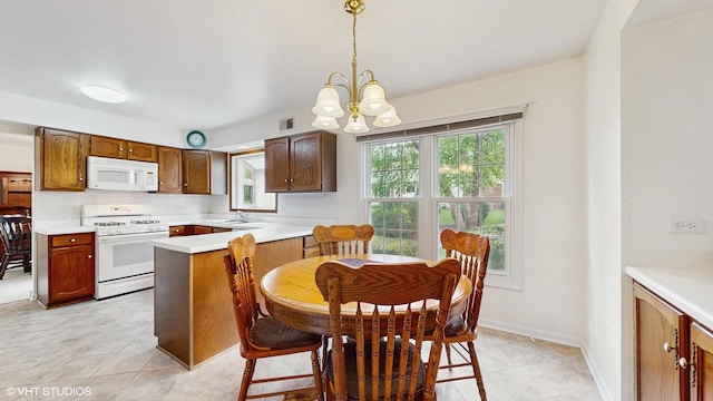 315 Carmelhead Ln, Schaumburg, IL 60193 - kitchen with white appliances, a sink, a chandelier, light countertops, and hanging light fixtures