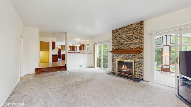 315 Carmelhead Ln, Schaumburg, IL 60193 - unfurnished living room with carpet flooring, a fireplace, and a chandelier