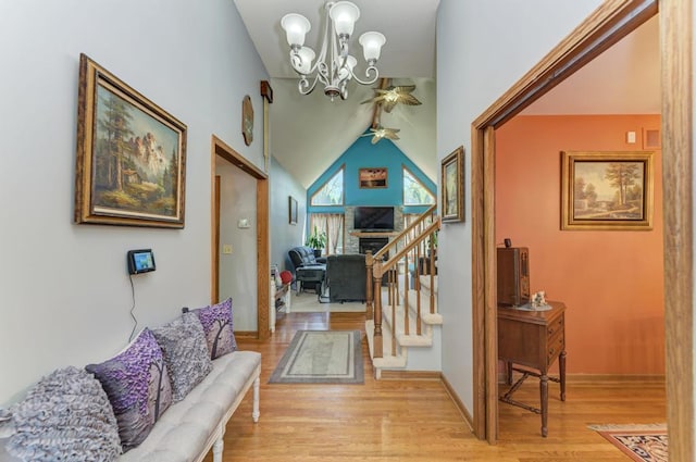 32911 Deer Ridge Dr, Wilmington, IL 60481 - hallway with light wood-style flooring, a chandelier, lofted ceiling, and stairs