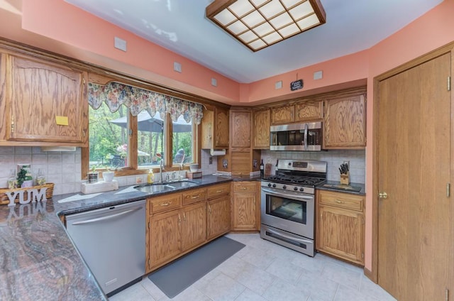 32911 Deer Ridge Dr, Wilmington, IL 60481 - kitchen featuring stainless steel appliances, a sink, brown cabinets, and decorative backsplash