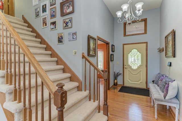 32911 Deer Ridge Dr, Wilmington, IL 60481 - entrance foyer featuring wood finished floors, stairway, a chandelier, a towering ceiling, and baseboards