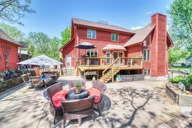 32911 Deer Ridge Dr, Wilmington, IL 60481 - back of house featuring a patio, a jacuzzi, a chimney, a wooden deck, and outdoor dining area