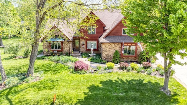 32911 Deer Ridge Dr, Wilmington, IL 60481 - view of front of property with a front lawn, a shingled roof, and brick siding